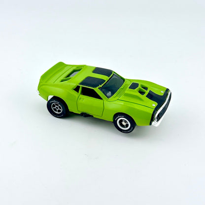Green toy car against white background. 