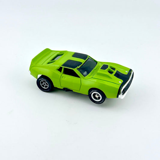 Green toy car against white background. 