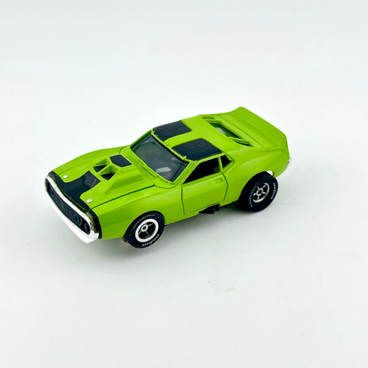 Green toy car against white background. 