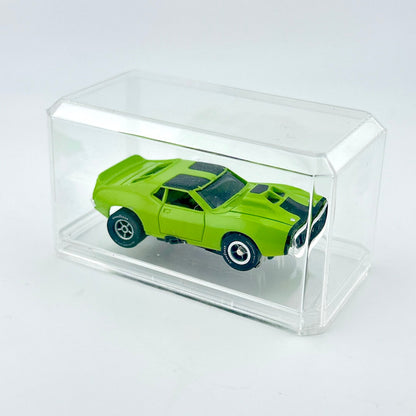 Green toy car inside clear rectangular display case. 
