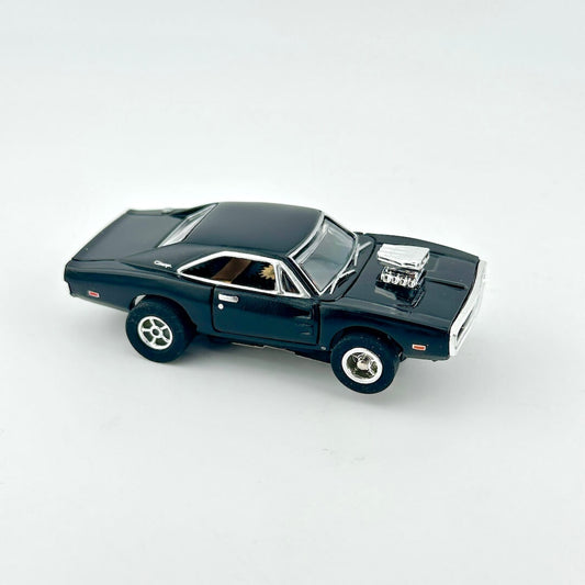 Black toy car with silver accents against white background. 