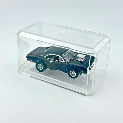 Black toy car inside clear rectangular display case. 