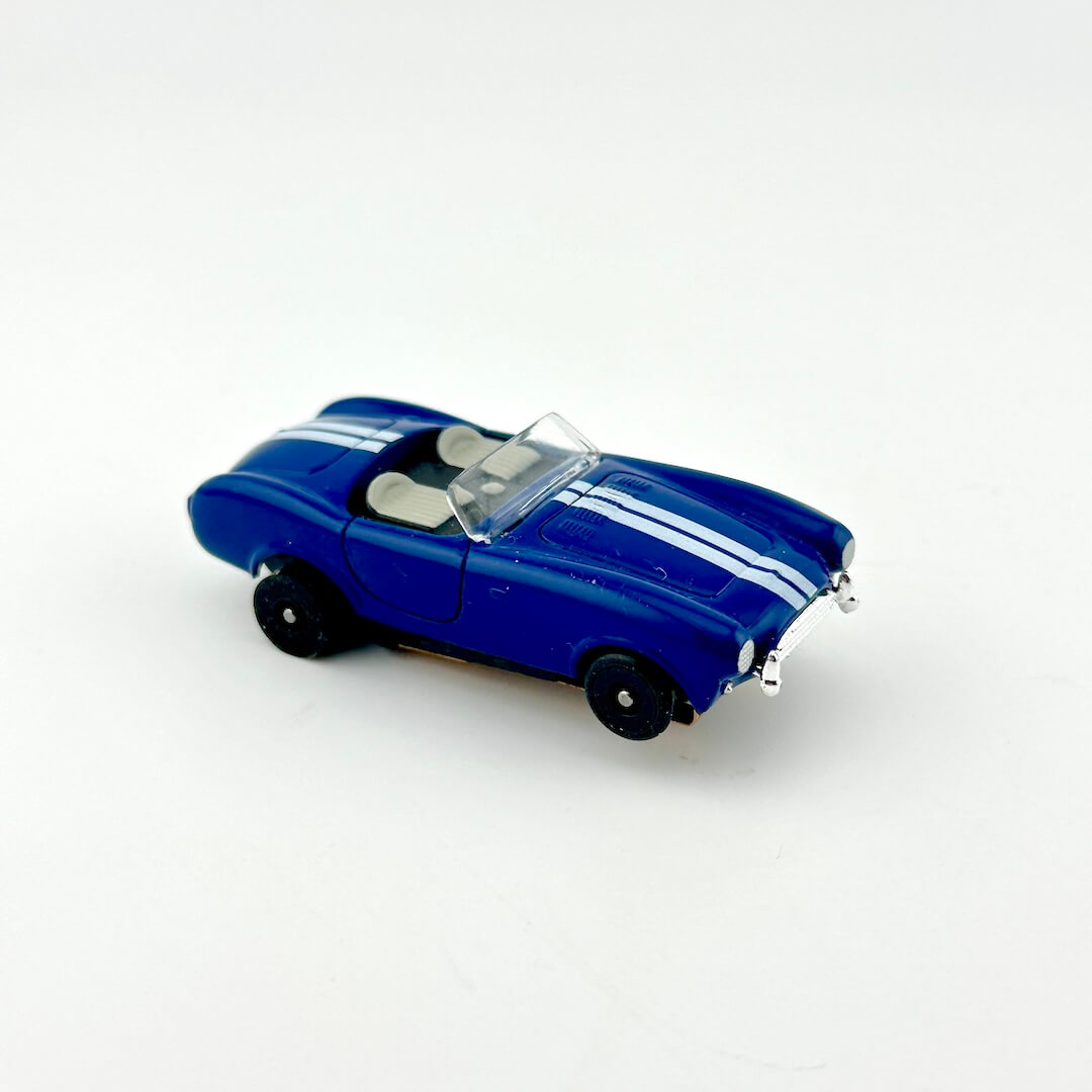 Blue model car with white stripes on a white background