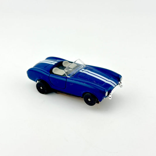 Blue model car with white stripes on a white background