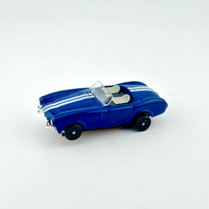 Blue model car with white stripes on a white background