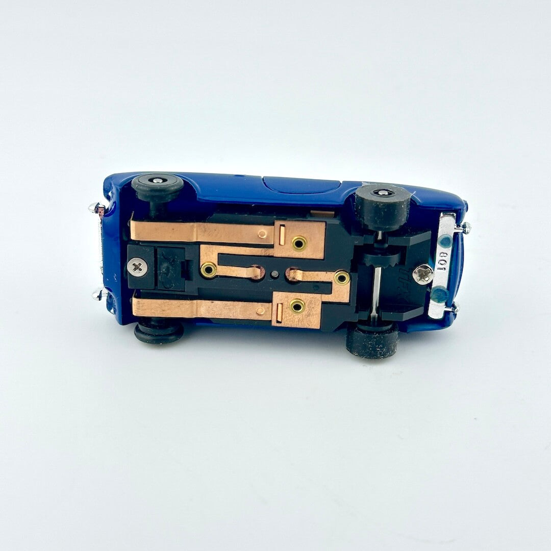 Blue mechanical component with gold and silver parts on a white background