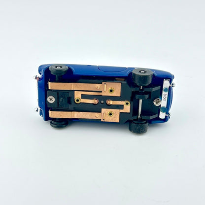 Blue mechanical component with gold and silver parts on a white background