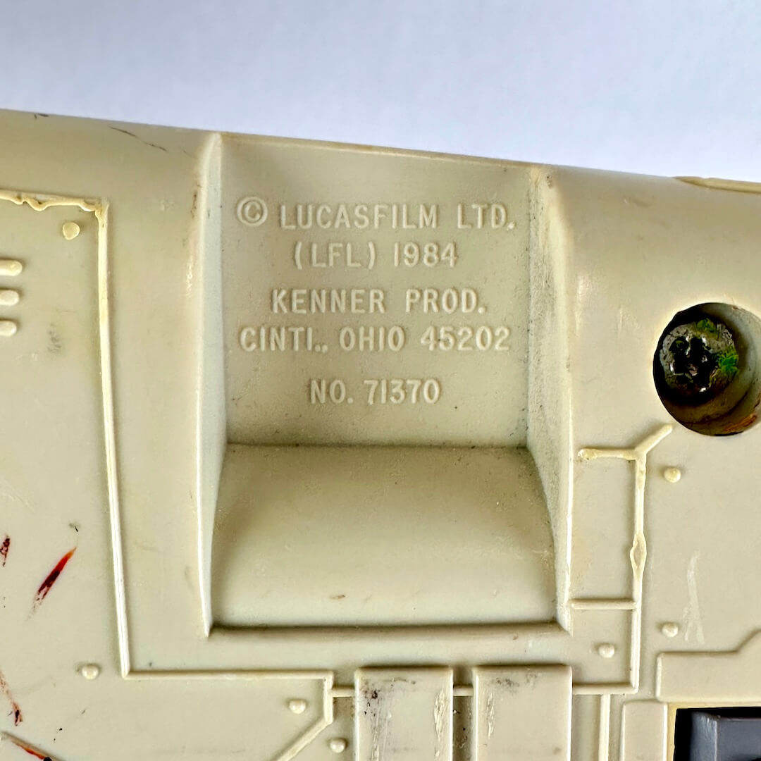 Close-up of molded beige plastic with embossed text reading 'Lucasfilm Ltd. (LFL) 1984 Kenner Prod.