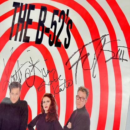 Close up of signature portion of poster under artist name and above their heads. 