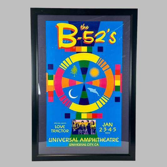 Blue poster with yellow text at top & bottom detailing B-52's show info. Multicolor circle graphic at center above band photo