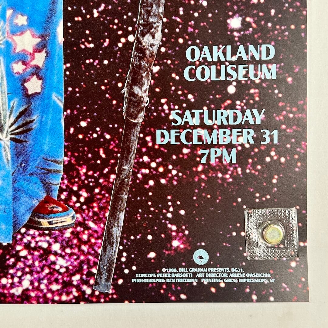 Bottom right corner of poster with no visible wear or damage held by magnet onto light surface. 