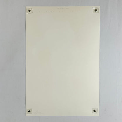 Backside of cream colored poster with no visible damage being held by magnets in the corners against light surface. 