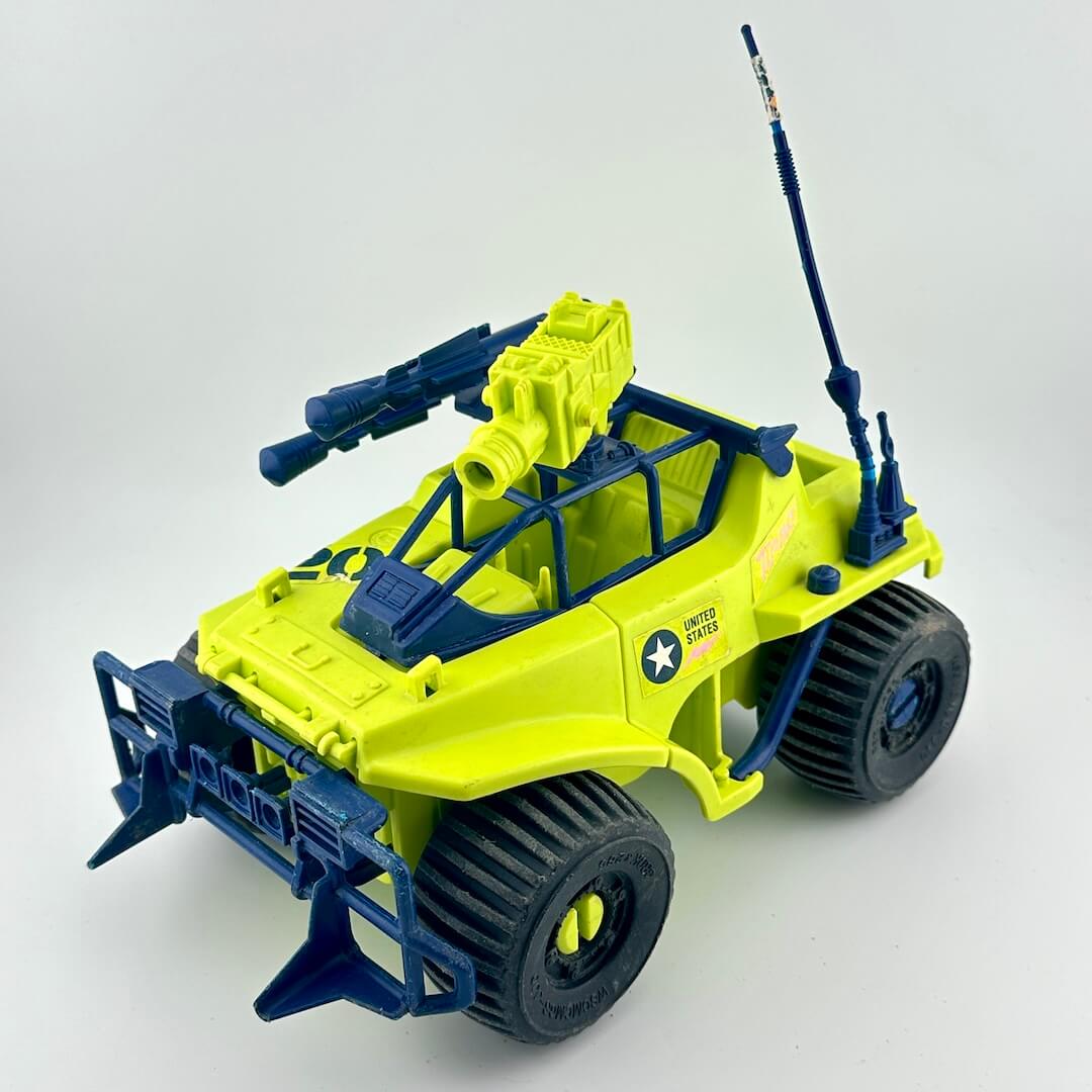 Toy vehicle with green and blue design on a white background