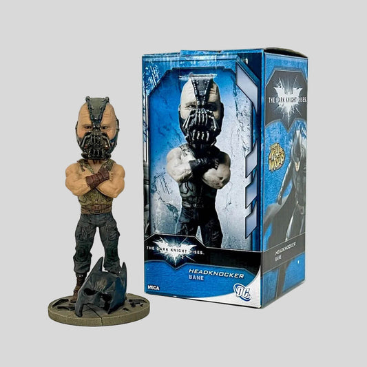 Box and bobblehead of Bane from Batman against white background. 