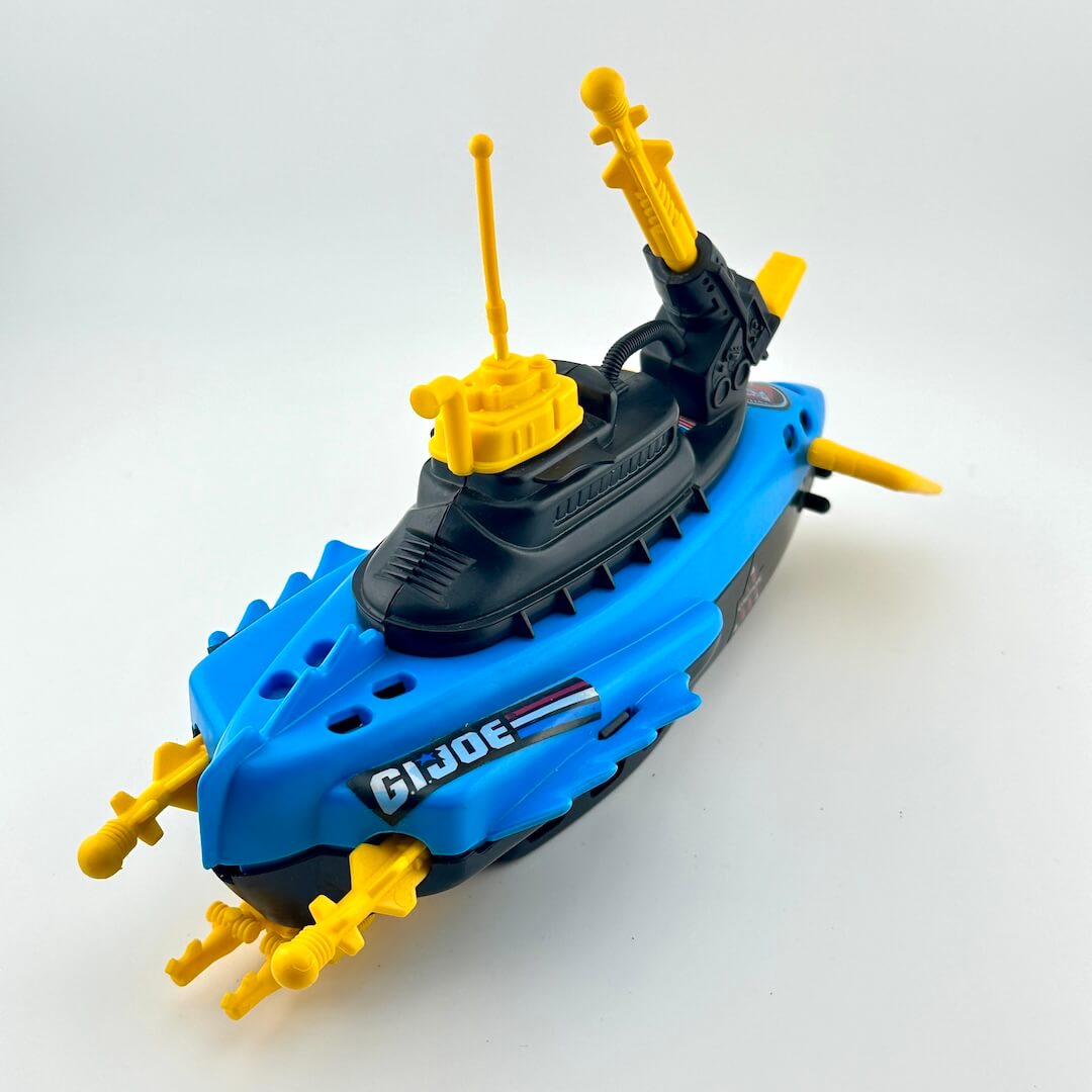 Toy submarine model with yellow periscopes and antennas on a white background