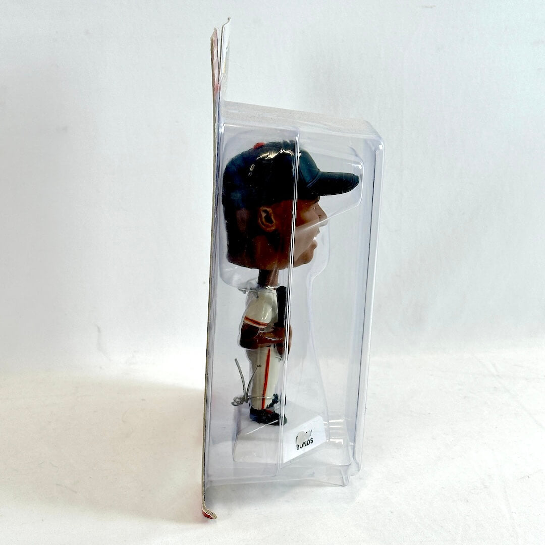 Bobblehead figure in a clear packaging on a white background