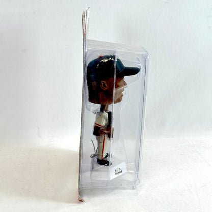 Bobblehead figure in a clear packaging on a white background