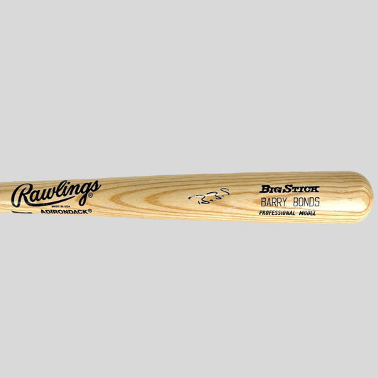 Baseball bat with text and signature against gray background. 