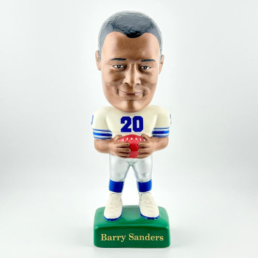 Bobblehead figure of a football player holding a ball on a white background