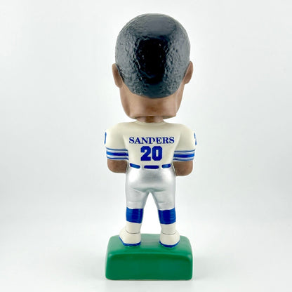 Bobblehead figure of a sports player in a white uniform with blue accents on a white background