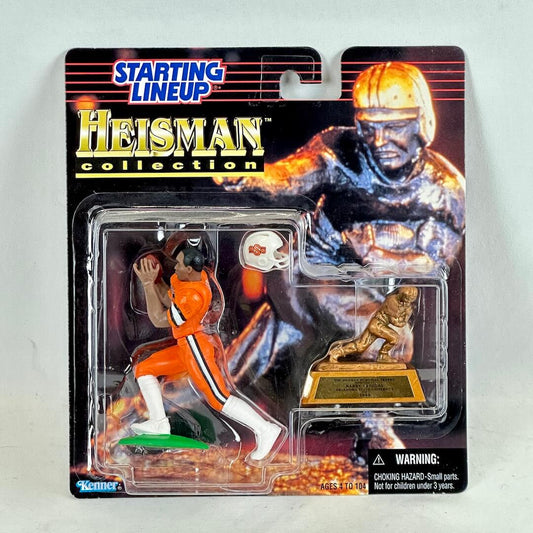 Heisman collection action figure packaging with football player and Heisman statue on a gray background