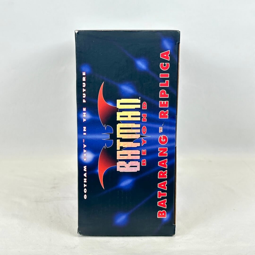 A boxed Batman replica product standing upright against a plain light background.