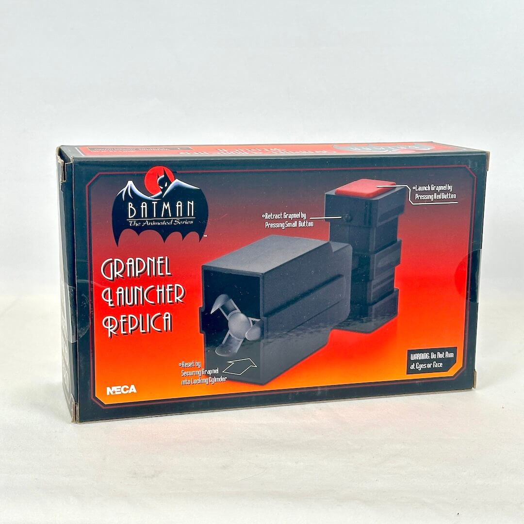A boxed replica grapple launcher from Batman: The Animated Series, manufactured by NECA. 