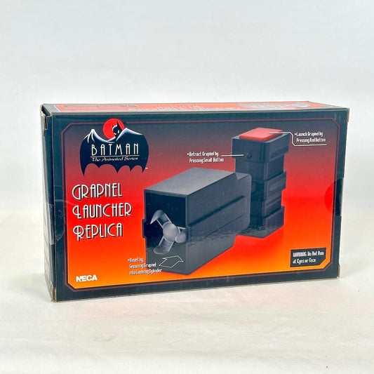 A boxed replica grapple launcher from Batman: The Animated Series, manufactured by NECA. 
