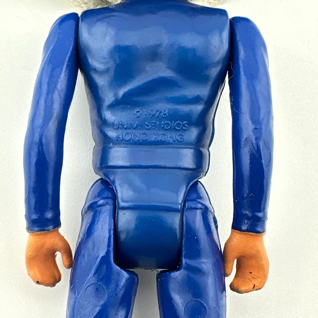 Blue action figure with 'UNIV. STUDIOS HONG KONG' branding on a white background
