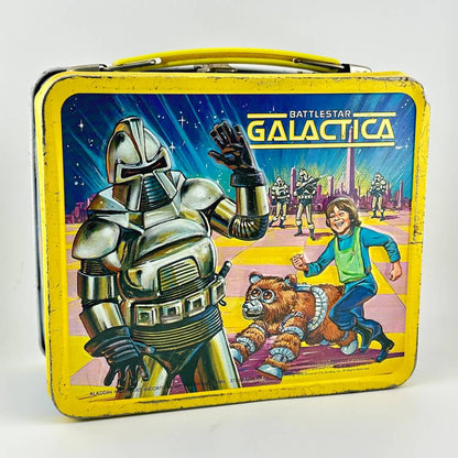Vintage lunchbox with yellow border and sci-fi imagery with robots, aliens, and a child pictured. 