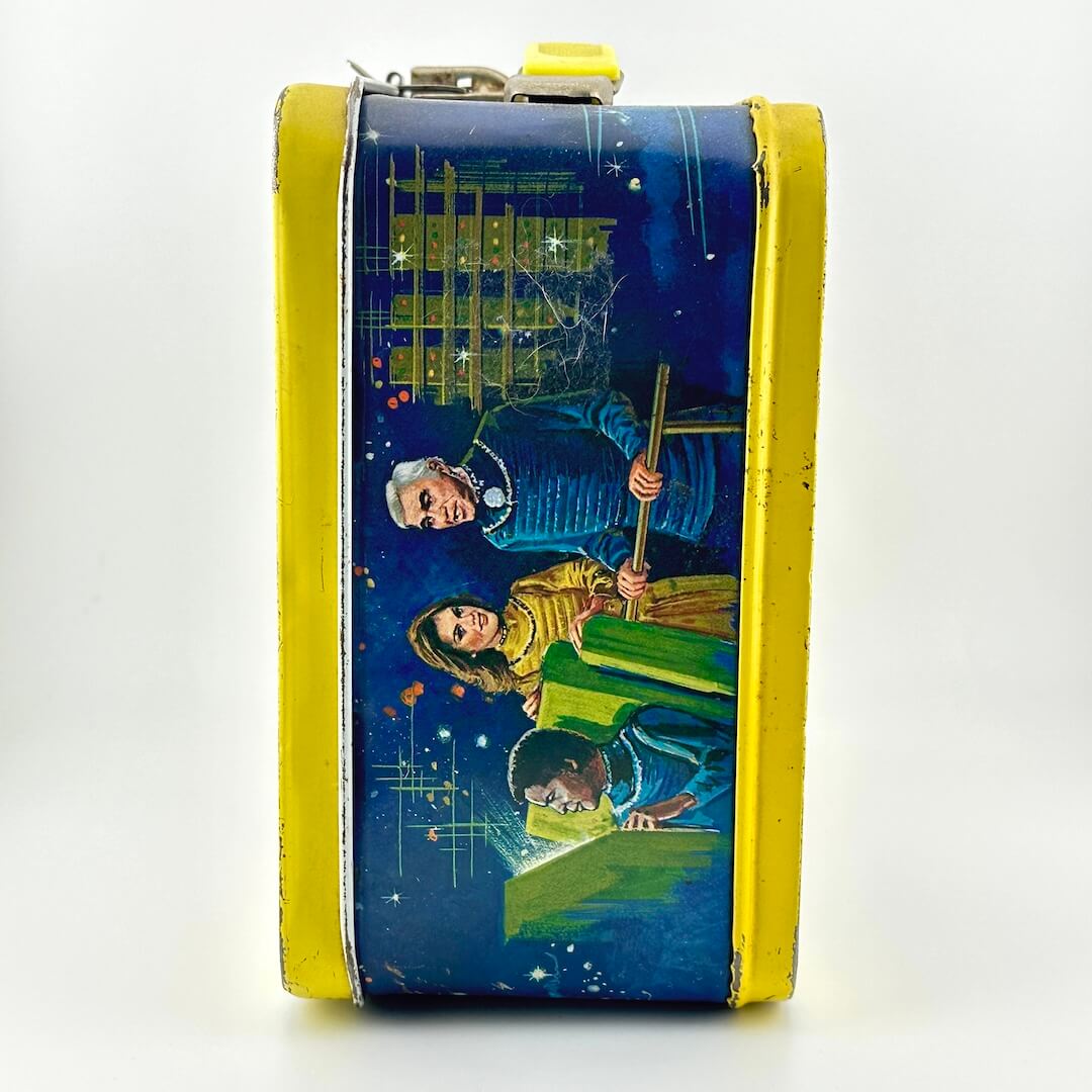 Side view of metal lunchbox with colorful illustrations of Battlestar Galactica characters. 