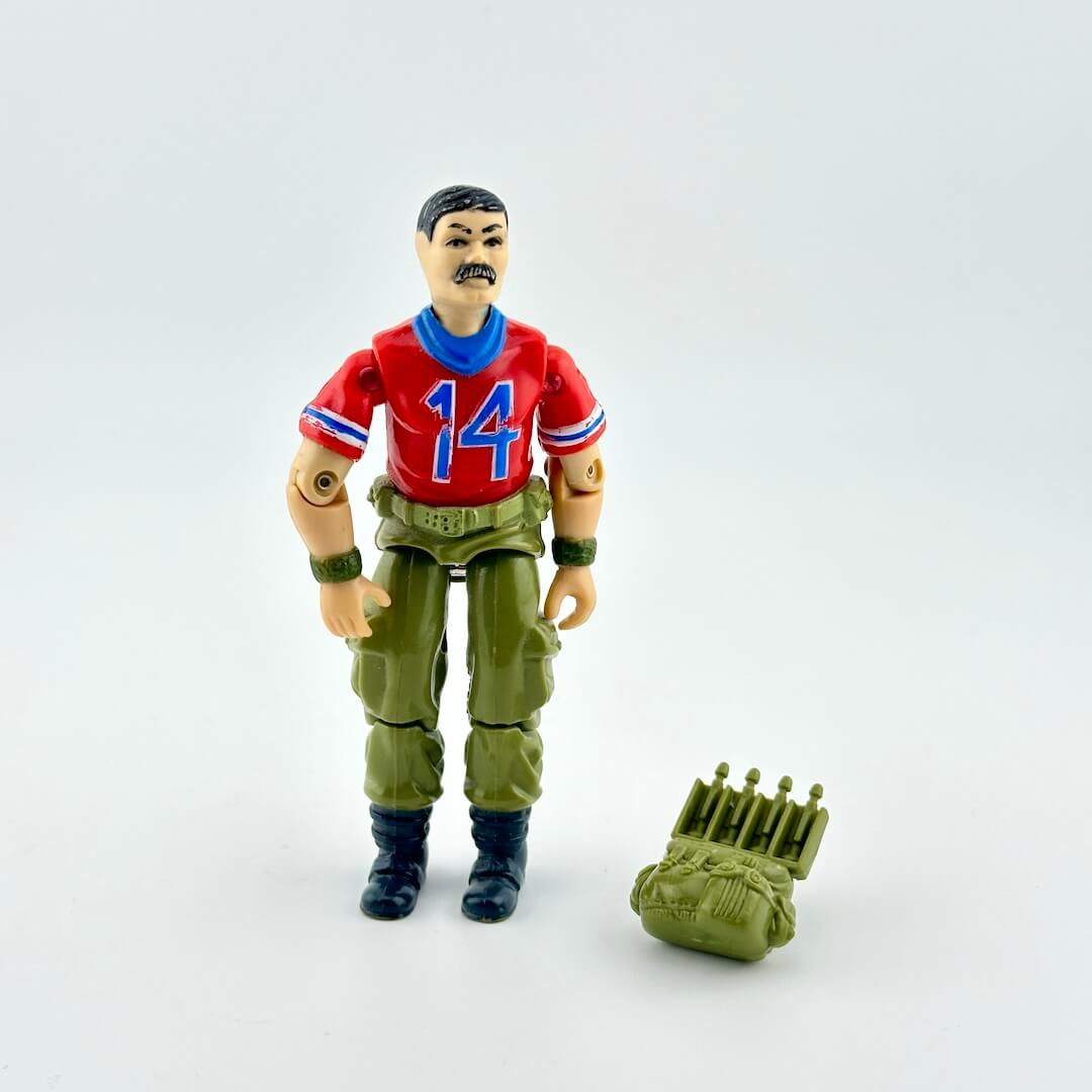 GI Joe action figure with accessory against white background. 