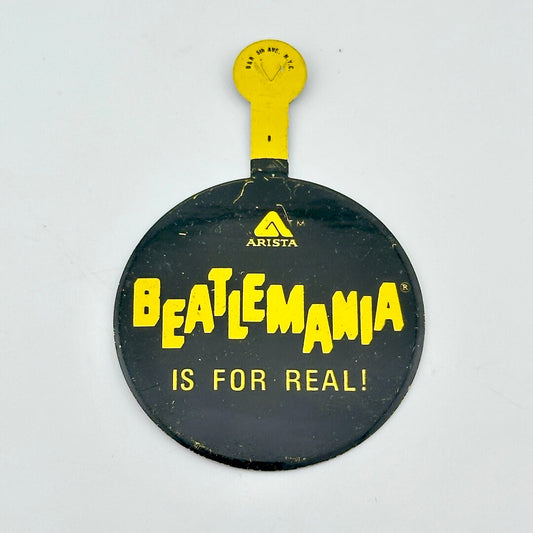 Black fold over pin with yellow text, "Beatlemania is for real!"