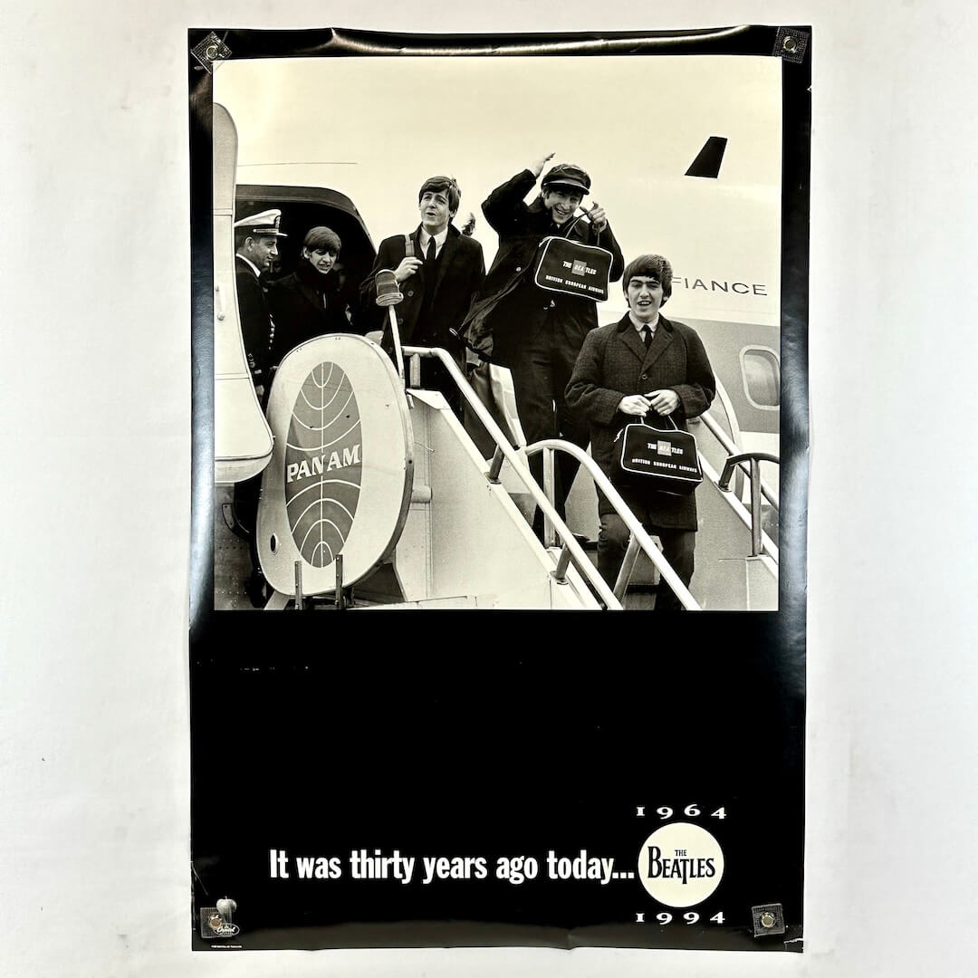 Black and white poster of The Beatles boarding a Pan Am plane with text 'It was thirty years ago today... 1964 1994'.