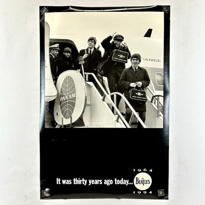 Black and white poster of The Beatles boarding a Pan Am plane with text 'It was thirty years ago today... 1964 1994'.