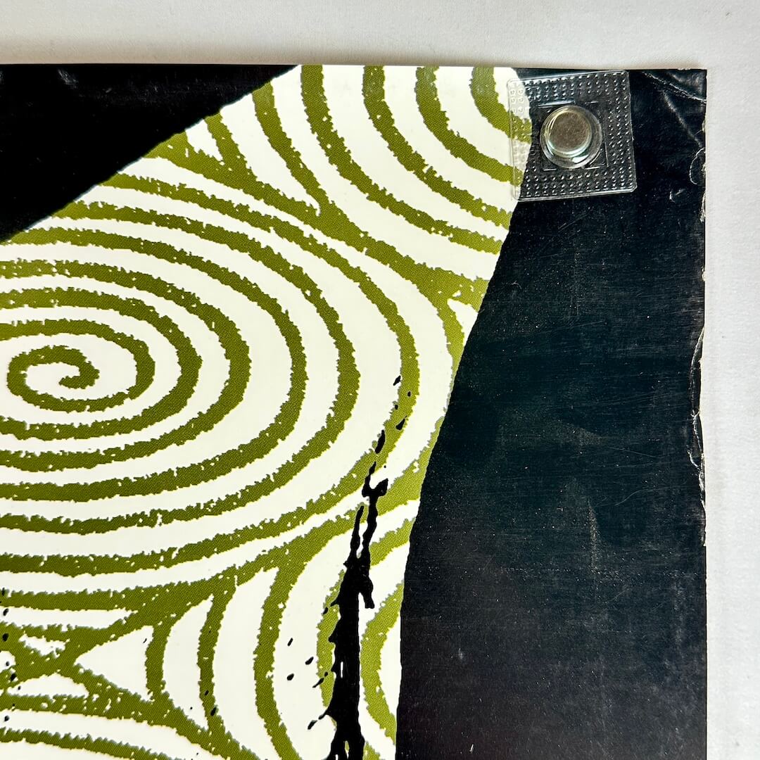 Top left corner of poster with edge wear to top. 