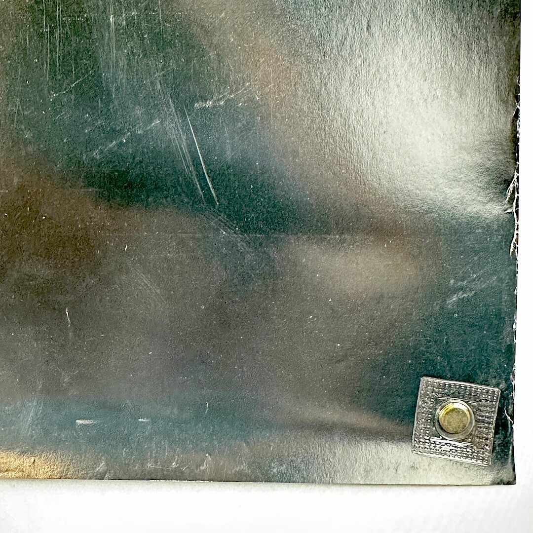 Black poster with edge wear to long edge. 