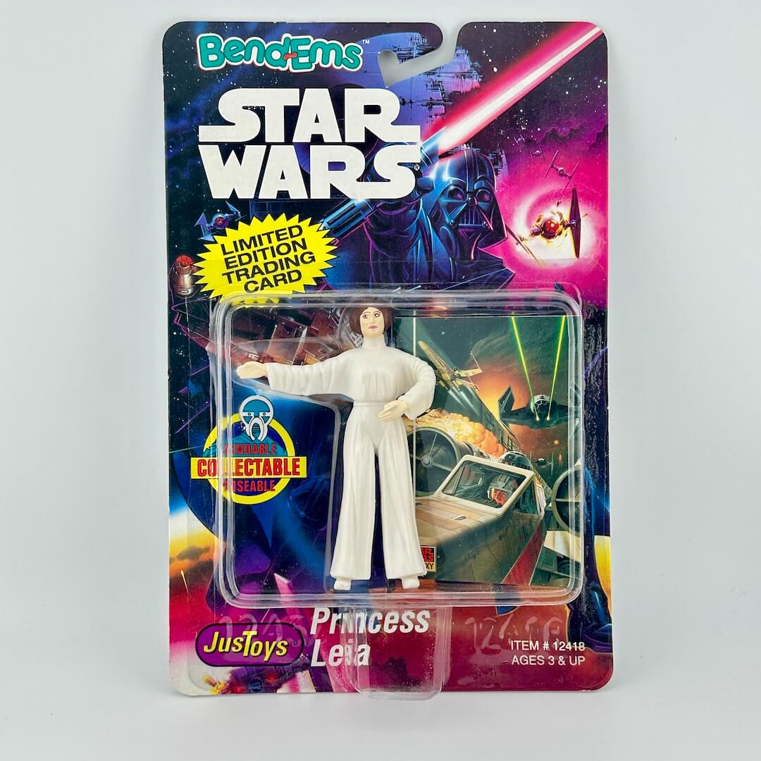 Princess Leia action figure in Star Wars branded packaging against gray background.