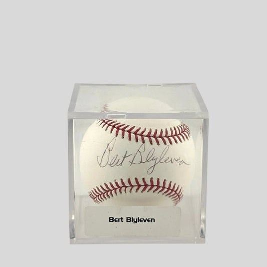 Autographed baseball in plastic cube with sticker label along bottom. 