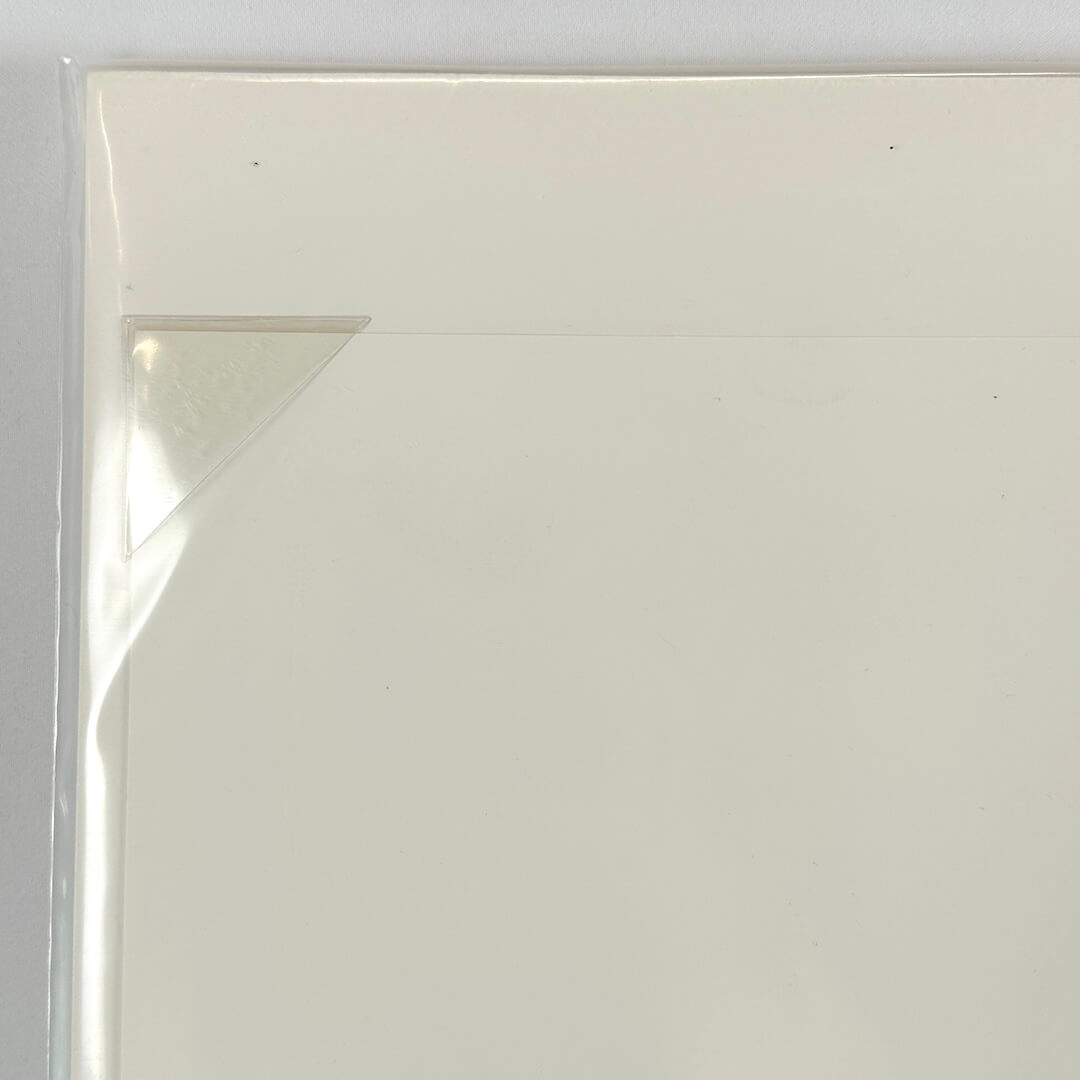 Top left corner of print tucked into protective corner, sleeved in plastic. 