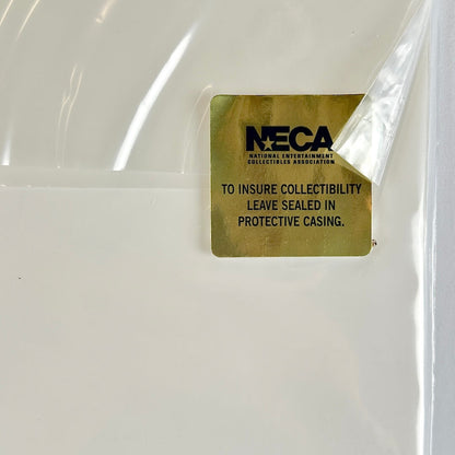 Gold label with 'NECA' text on a clear plastic casing