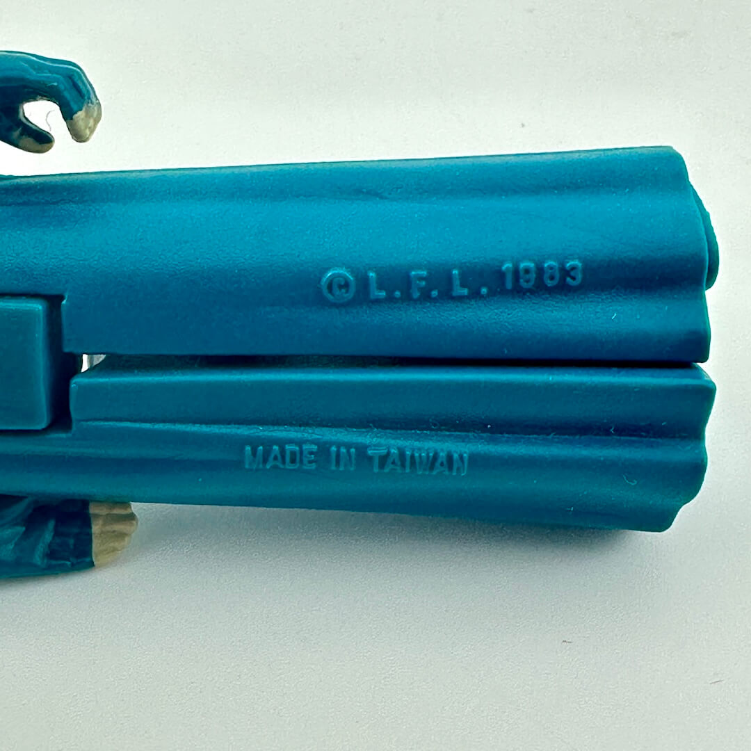 Close-up of back of figure's legs to show 'L.F.L. 1983' and 'Made in Taiwan' text on a white background