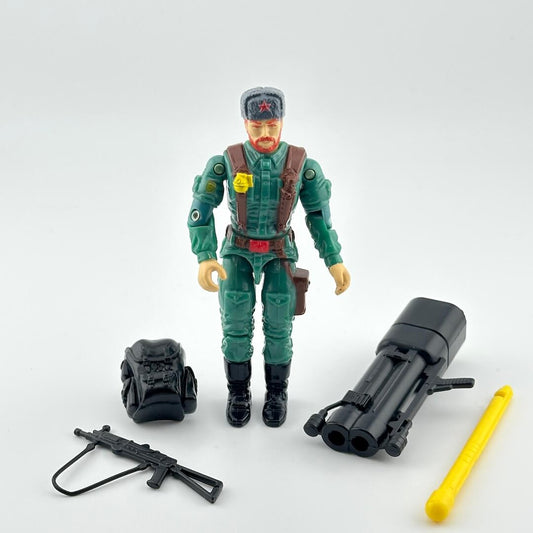Toy figure in green military uniform with accessories on a white background