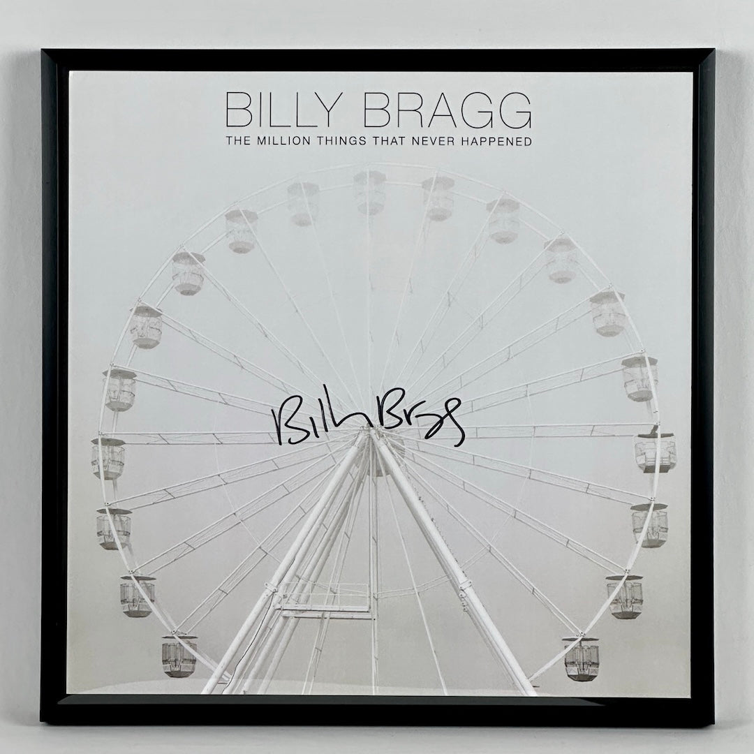 Black & white photo of Ferris Wheel that fades as it approaches the top where BILLY BRAGG & album title are in black text.