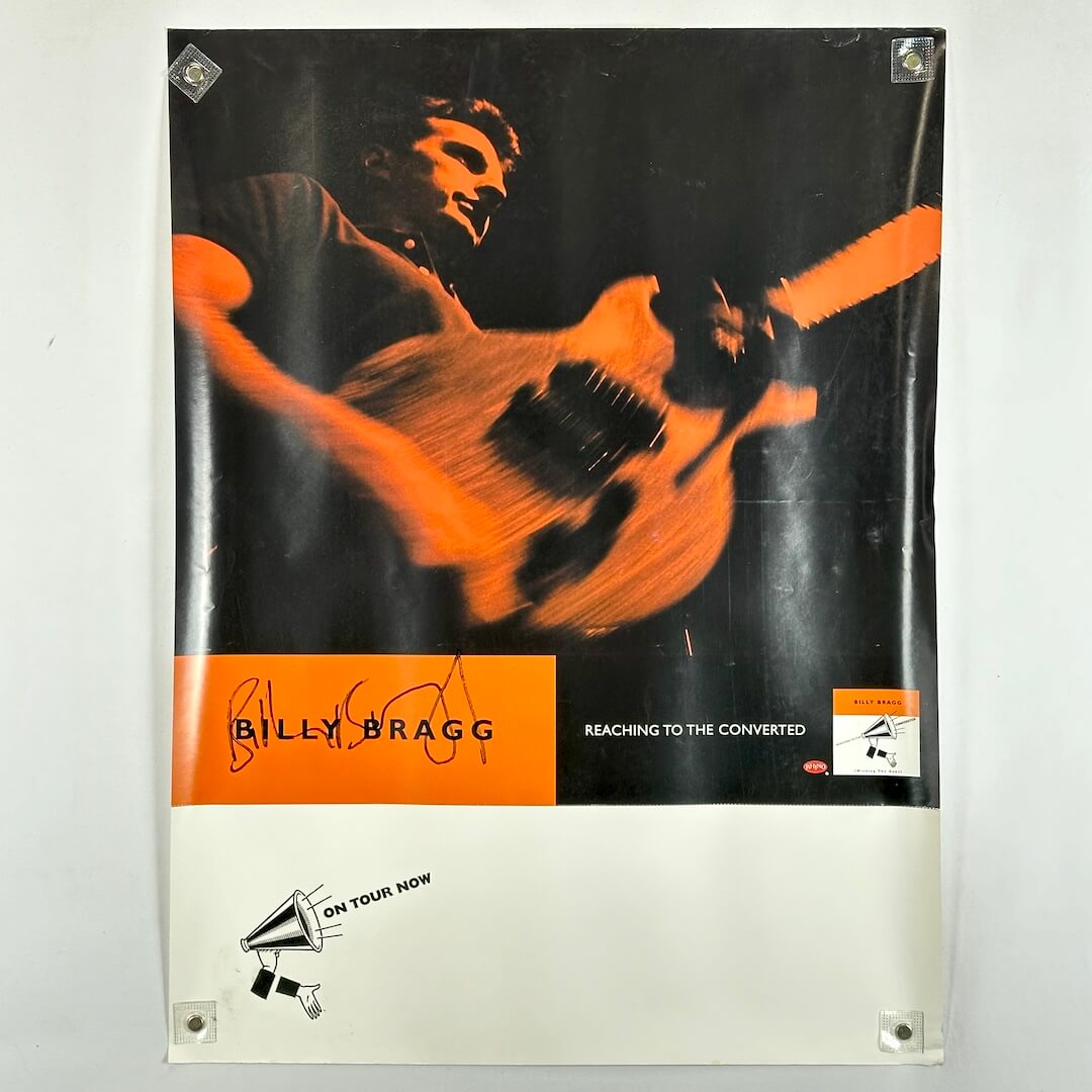 Promo poster with man playing guitar in orange against black background with banners at bottom. 