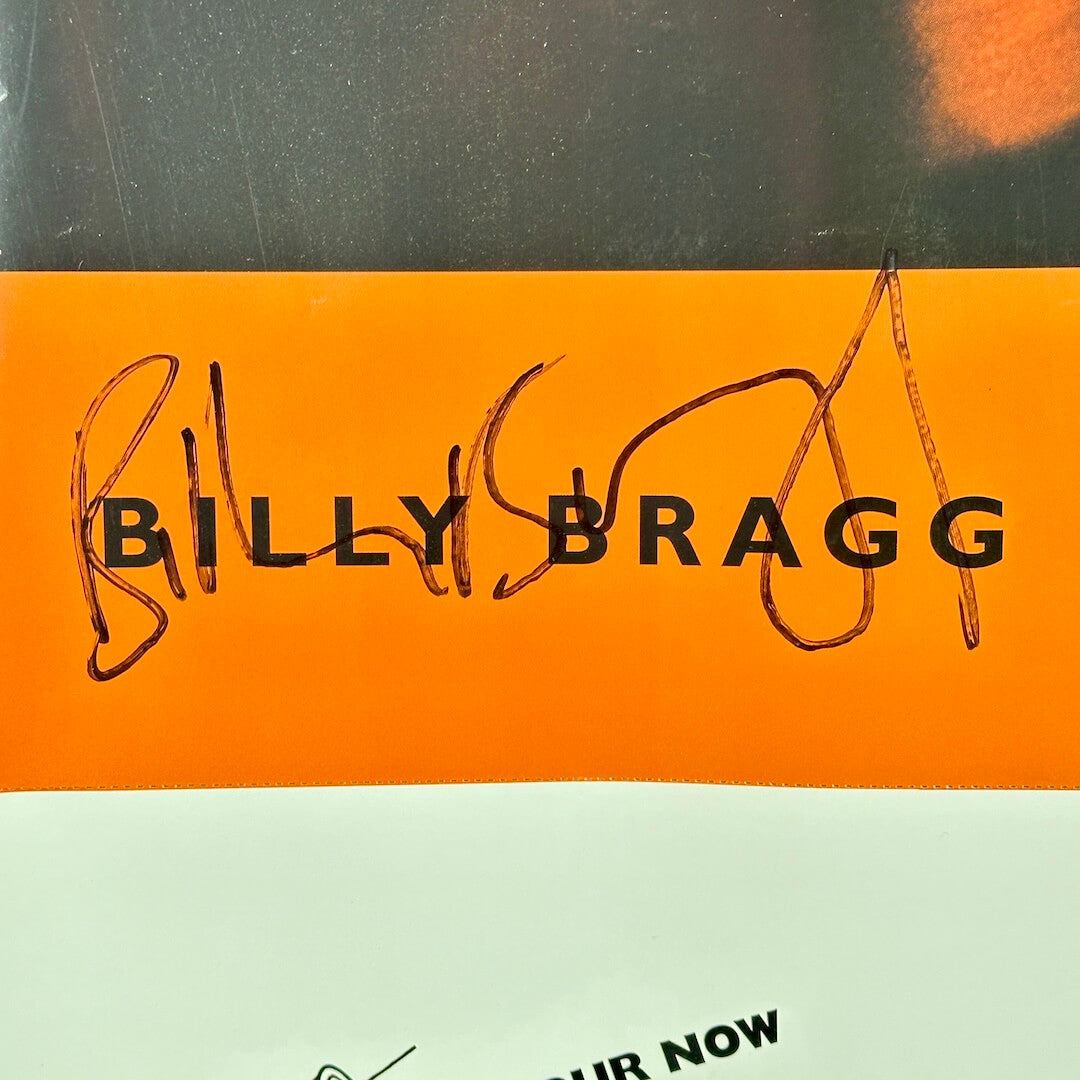 Close-up of Billy Bragg signature over printed artist name on poster. 