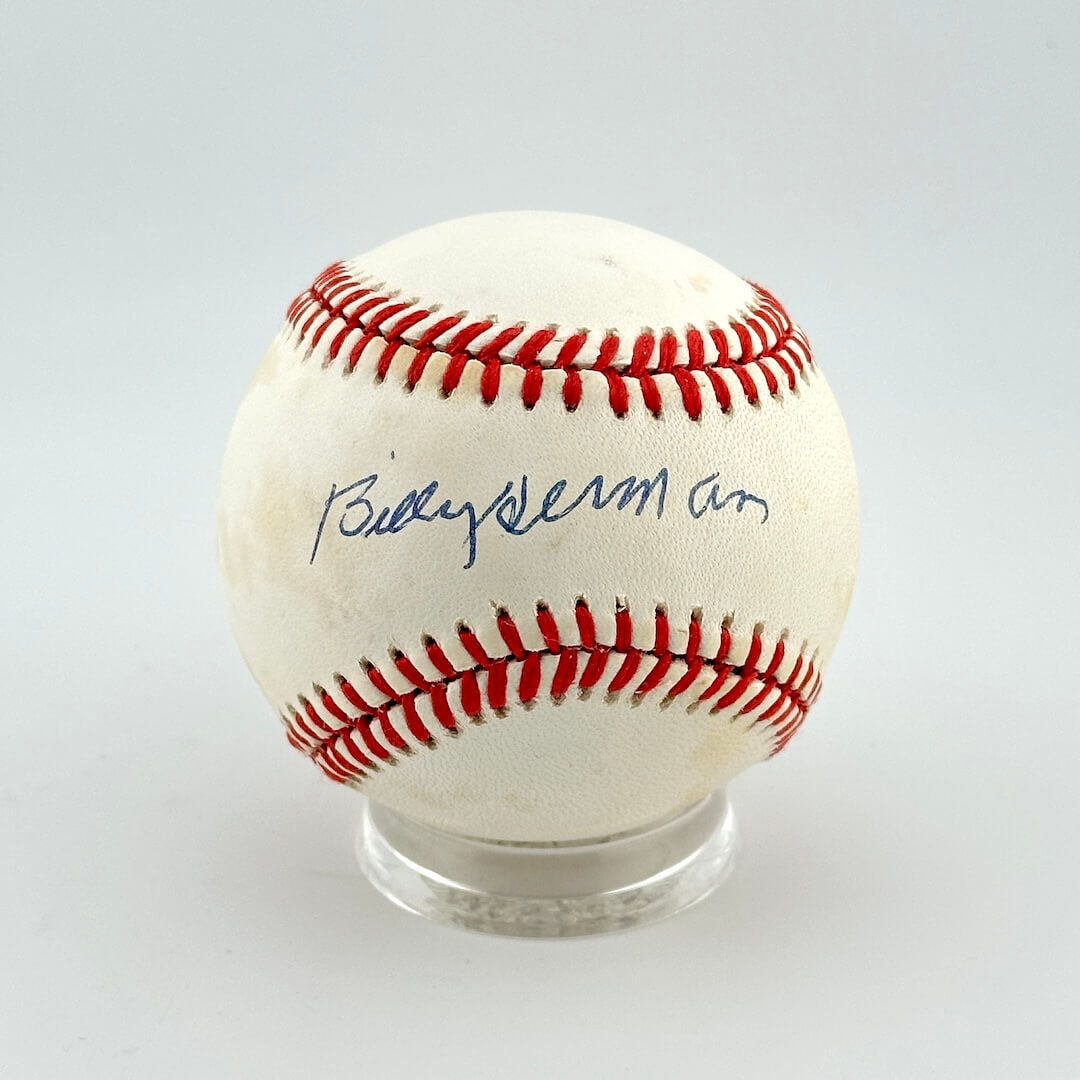 Baseball with red stitching on a white background