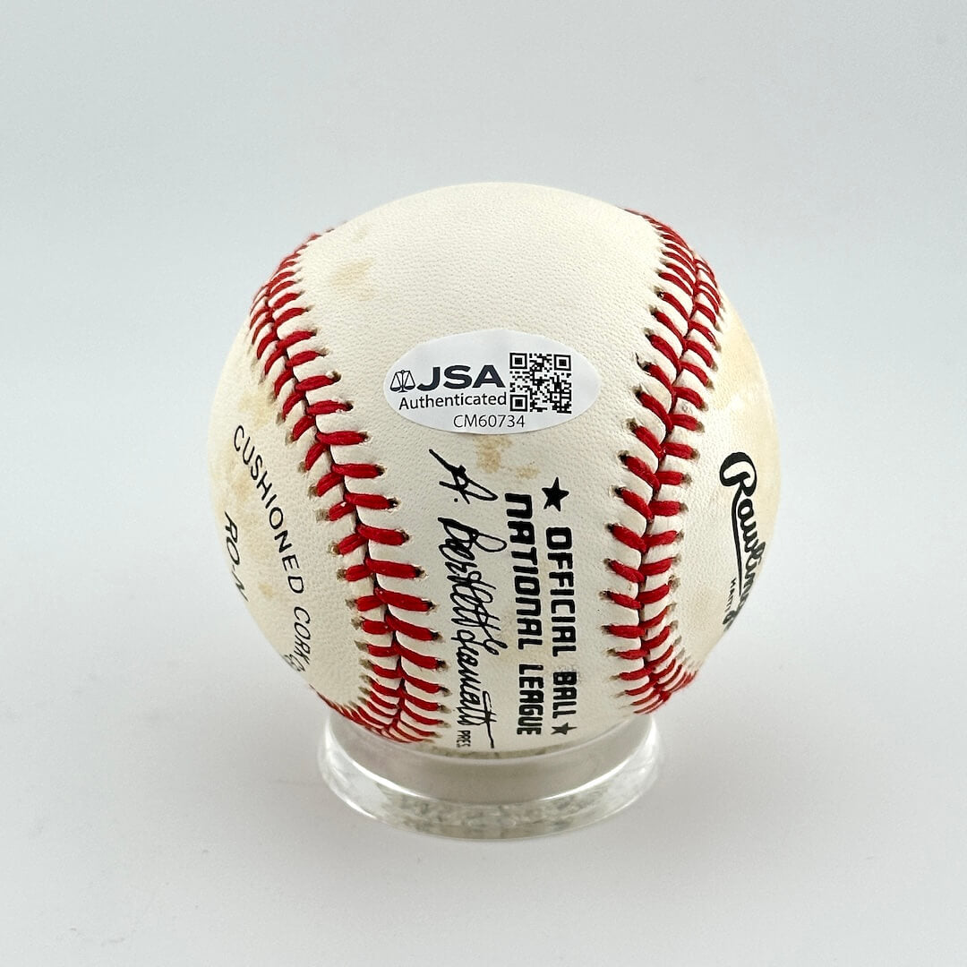 Baseball with JSA authentication label on a white background