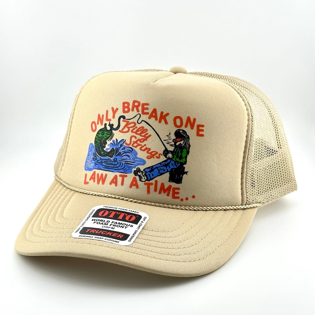 Beige cap with fishing graphic and text on a white background