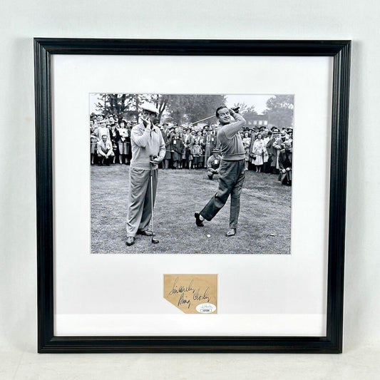 A framed black-and-white photograph of golfers on a course, mounted with a white mat and a black frame with signature at bottom. 